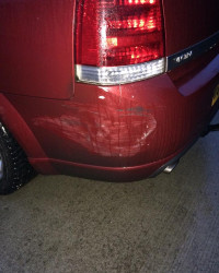 An image of a red car scrapes on the back