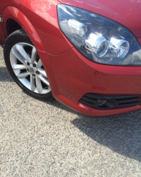 An image of the same red car after we repaired its bumper