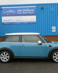 Blue mini cooper outside garage